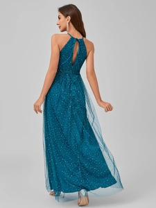 Detail of teal halter neck evening gown showing mesh overlay and white polka dot pattern