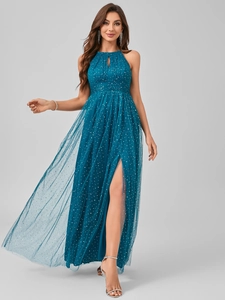 Detail view of the halter neck design and white polka dots on the blue evening gown