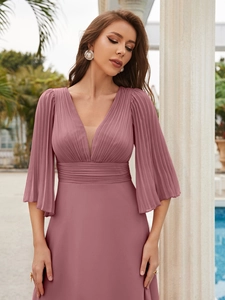Detail of the elegant V-neckline and ruffled bell sleeves on the chiffon evening gown