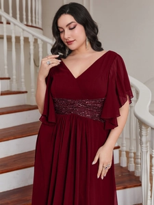 Close-up of elegant V-neckline and flutter sleeves on wine red sequin evening dress
