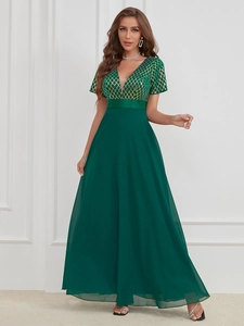 Detail of elegant dark green V-neck evening dress featuring sequin mesh and chiffon skirt