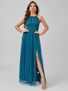 Detail of teal halter neck evening gown with sequin mesh fabric and high side slit