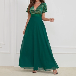 Detailed view of dark green V-neck evening gown with sequined diamond pattern and chiffon skirt