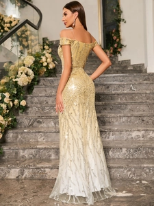 Detail of elegant sequined off-shoulder fishtail evening gown with gradient effect