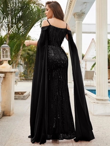 Detail of elegant black sequin evening gown showing shoulder straps and floor-length sleeves