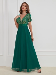 Elegant emerald green V-neck evening dress with sequin bodice and flowing chiffon skirt