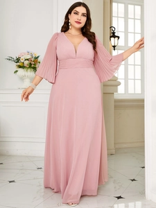 Close-up of pink V-neck evening dress showing pleated high waist and chiffon texture