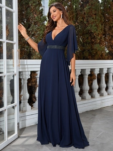 Detail of elegant V-neck evening gown with sparkling rhinestone belt and chiffon sleeves