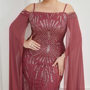 Detailed close-up of burgundy sequin gown with embroidery and sheer chiffon sleeves