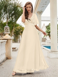 Detail of V-neck sequined bodice and flowing chiffon skirt on a champagne evening dress