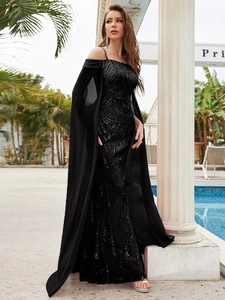 Detail of elegant black sequin evening gown featuring a long chiffon cape and shimmering texture