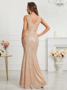 Detailed view of champagne gold sequined evening gown with backless design and fishtail hem