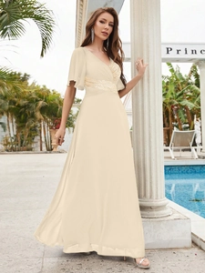 Detail view of champagne V-neck chiffon evening gown with sequin embroidery and butterfly sleeves