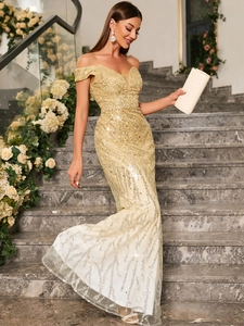Close-up of champagne gold sequins on an off-shoulder mermaid evening dress with V-neck detail