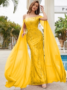 Detail of yellow sequin evening gown featuring off-shoulder design and long cape sleeves