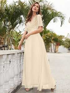 Detail of elegant V-neck champagne gown with golden sequins and ruffles