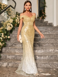 Close-up of golden sequins and embroidery on off-shoulder mermaid evening gown