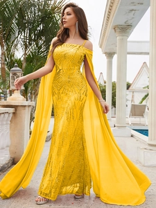 Detailed close-up of yellow sequin evening gown with geometric patterns and cape sleeves