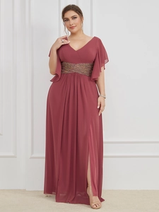 Detail of the elegant V-neck gown featuring ruffled sleeves and a sequined waist belt