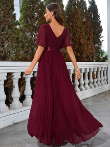 Detail of elegant V-neck wine red chiffon gown featuring pleated skirt and ruffled sleeves