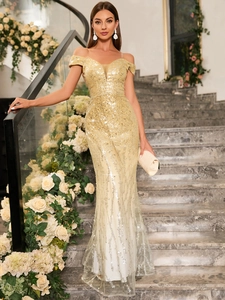 Detail of champagne gold sequin off-shoulder evening dress with elegant fishtail silhouette
