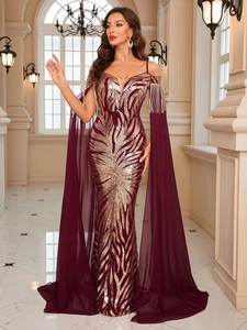 Detail of burgundy sequin evening dress featuring rose gold leaf patterns and tassel straps