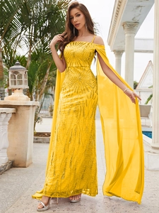 Detail of sequined long evening dress in bright yellow with chiffon shawl and textures