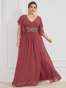 Macro shot of V-neck ruffled bodice with shimmering sequin belt on wine red chiffon dress