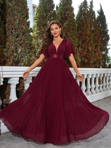 Detail of burgundy V-neck chiffon evening dress with flutter sleeves and pleated skirt
