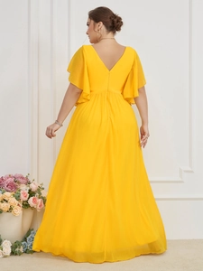 Detail view of deep V-neck back design on an elegant yellow chiffon maxi dress with ruffles