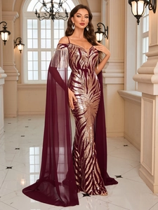 Detail of burgundy evening gown featuring gold sequins and chiffon cape sleeves