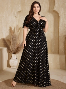 Close-up of black chiffon maxi dress featuring golden polka dots and elegant V-neckline