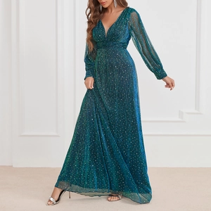 Detailed close-up of teal sequin evening gown showing shimmering fabric and V-neckline