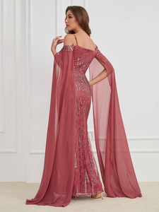 Detail of sequined fishtail evening gown with off-shoulder cut and long chiffon cape sleeves