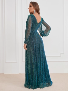 Macro detail of dark green sequin gown with pleated texture and elegant lantern sleeves