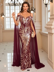Macro view of burgundy gown with golden fringe on cold shoulder and sequin details