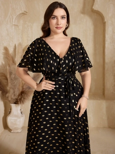 Detail of V-neck chiffon midi dress featuring gold polka dots and ruffle short sleeves
