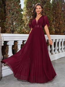 Detail of burgundy chiffon evening dress featuring a deep V-neck and pleated skirt design
