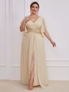 Detailed close-up of champagne V-neck maxi dress featuring sequined waist and chiffon texture