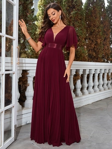 Detailed view of the deep V-neckline and flutter sleeves on this burgundy evening gown