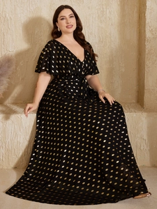 Detail of V-neck maxi dress featuring gold polka dots and ruffled short sleeves