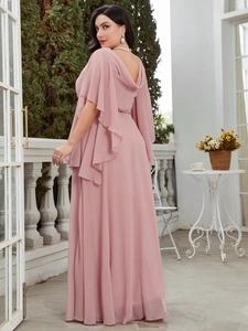 Detail of elegant dusty pink chiffon maxi dress with flutter sleeves and V-back design
