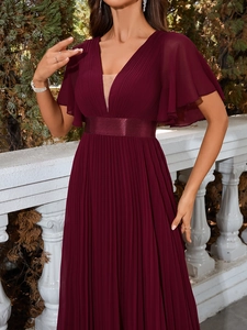 Detailed view of the V-neckline and ruffled short sleeves on this elegant burgundy maxi dress