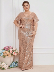 Detail of champagne gold evening dress with geometric sequins and elegant butterfly sleeves