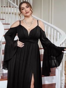 Detail of elegant black cold-shoulder evening gown with slit skirt and bell sleeves