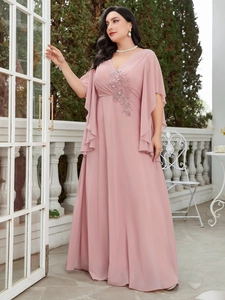 Detailed close-up of exquisite floral beadwork and embroidery on pink chiffon evening gown