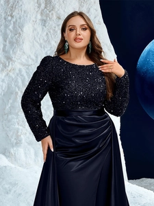 Detailed view of sequined bodice and pleated satin skirt on a navy evening gown