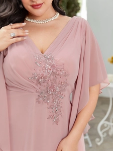 Detail of beaded floral embroidery and sequins on a V-neck chiffon evening dress