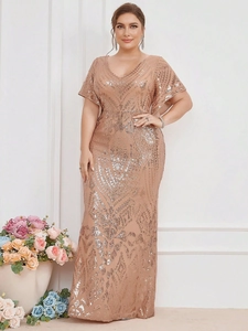 Close-up of elegant gold sequins and geometric patterns on a V-neck evening gown
