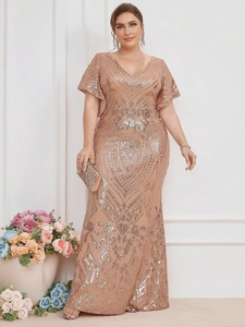 Close-up of sparkling silver sequin embroidery on luxury champagne V-neck evening gown